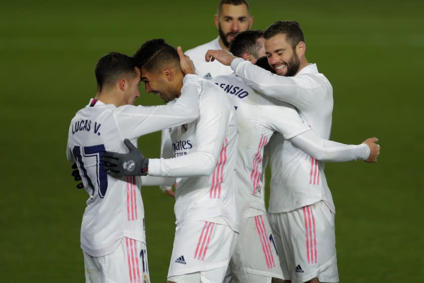 Real Madrid's Marco Asensio, second right, celebrates with teammates Nacho, right, Casemiro, second left, and Lucas Vazquez, left, after scoring his side's second goal during the Spanish La Liga soccer match between Real Madrid and Celta Vigo at the Alfredo Di Stefano stadium in Madrid, Spain, Saturday, Jan. 2, 2021. (AP Photo/Manu Fernandez)