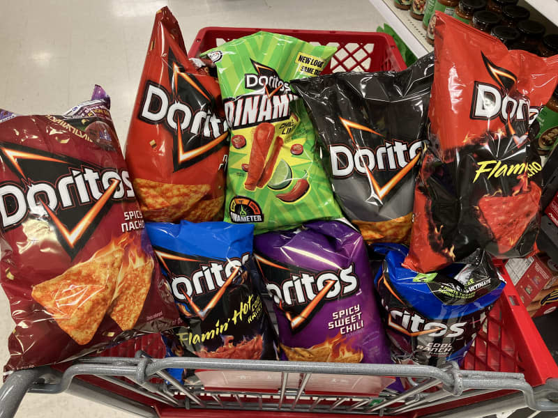 Multiple bags of Doritos in a grocery shopping cart