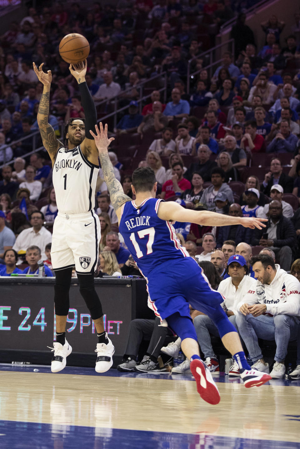 Brooklyn Nets' D'Angelo Russell, left, shoots the ball with Philadelphia 76ers' JJ Redick, right, defending during the second half in Game 5 of a first-round NBA basketball playoff series, Tuesday, April 23, 2019, in Philadelphia. The 76ers won 122-100. (AP Photo/Chris Szagola)