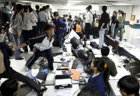 Factory workers smash up an office during a protest at Kaida toy factory in Dongguan, Guangdong province, in this November 25, 2008 file photo. REUTERS/Stringer