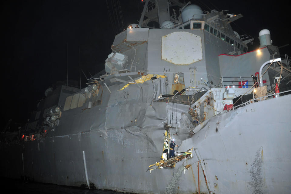 In this photo provided by the U.S. Navy, Sunday, Aug. 12, 2012, personnel examine the guided-missile destroyer USS Porter after it was damaged in a collision with the Panamanian flagged, Japanese-owned bulk oil tanker M/V Otowasan in the Strait of Hormuz early Sunday. (AP Photo/U.S. Navy, Petty Officer 3rd Class Jonathan Sunderman)