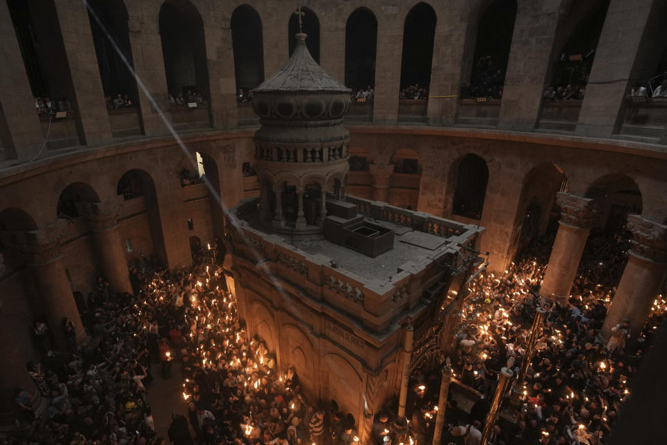 Christian pilgrims hold candles during the Holy Fire ceremony, a day before Easter, at the Church of the Holy Sepulcher, where many Christians believe Jesus was crucified, buried and resurrected, in Jerusalem's Old City, Saturday, April 15, 2023. (AP Photo/Mahmoud Illean)