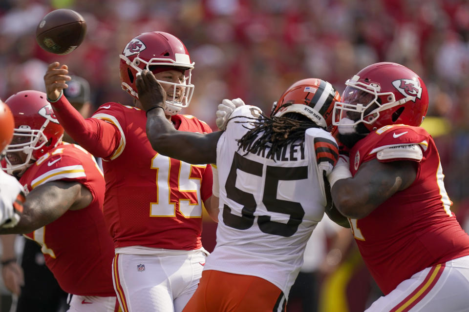 Kansas City Chiefs quarterback Patrick Mahomes (15) throws over Cleveland Browns defensive end Takkarist McKinley (55) during the first half of an NFL football game against the Cleveland Browns Sunday, Sept. 12, 2021, in Kansas City, Mo. (AP Photo/Charlie Riedel)