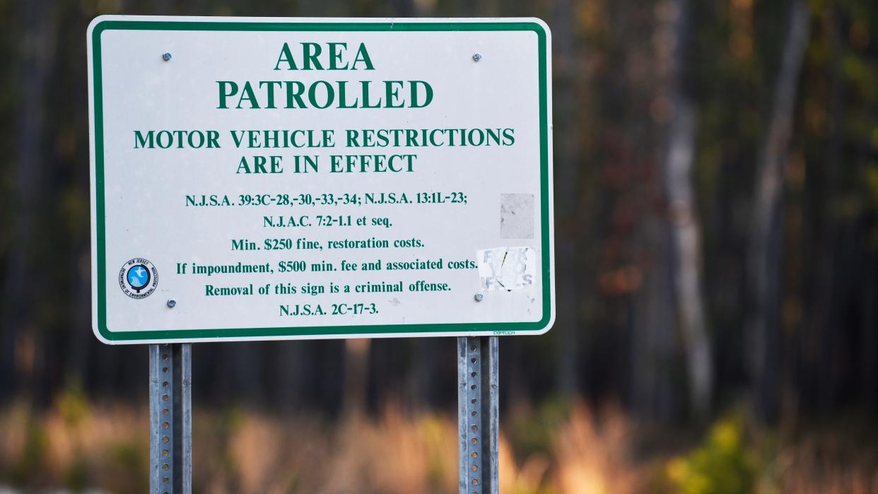 A sign is posted on Washington Turnpike in the Pine Barrens, about 7 miles away from the site where a pilot and a photographer were killed when Action News' helicopter Chopper 6 crashed in a wooded area of Burlington County, New Jersey, on Tuesday night, the station reported Wednesday morning.