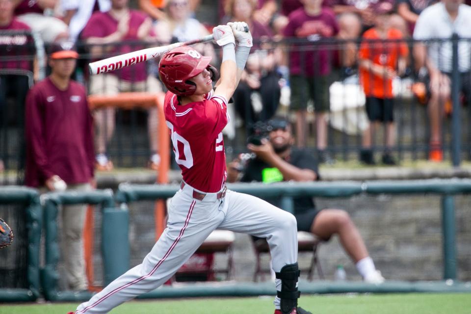 Oklahoma's Peyton Graham hits a solo home run against Virginia Tech in the first inning of an NCAA college super regional baseball game Sunday, June 12, 2022, in Blacksburg, Va. (AP Photo/Scott P. Yates)