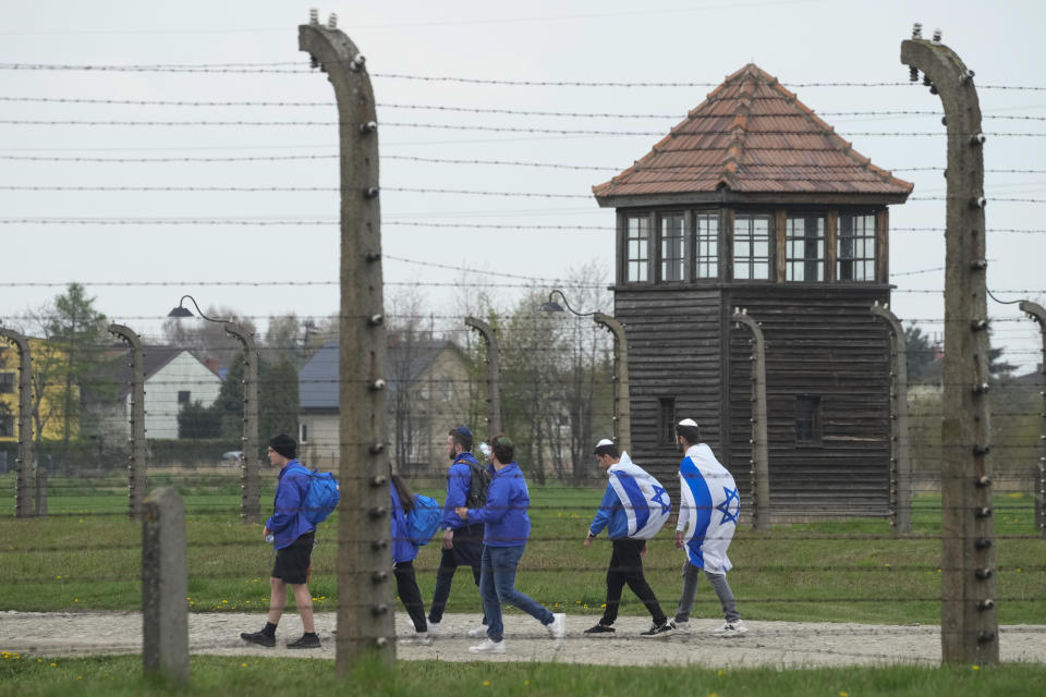 FILE - Jewish people visit the Auschwitz Nazi concentration camp after the March of the Living annual observance, in Oswiecim, Poland, April 28, 2022. Israel's national Holocaust memorial has criticized a new agreement renewing Israeli school trips to Poland, saying it recommends a number of "problematic sites" that distort history. (AP Photo/Czarek Sokolowski, File)