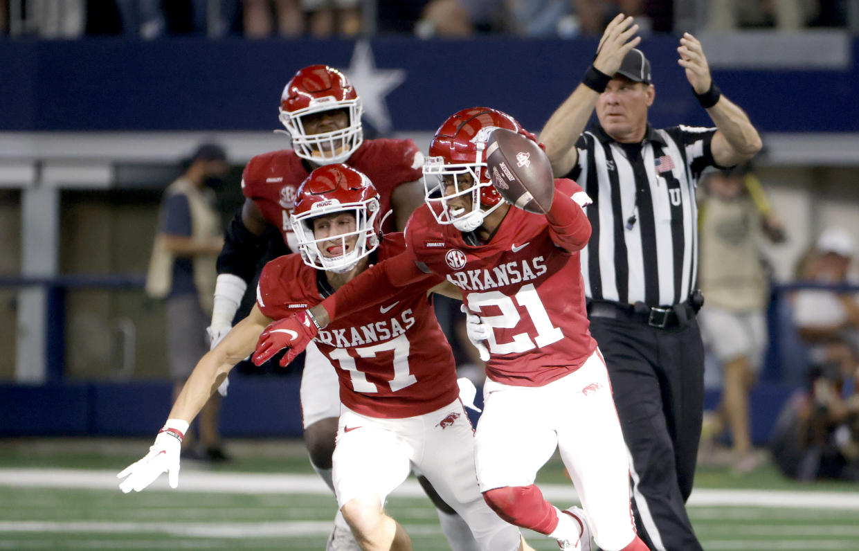 ARLINGTON, TX - SEPTEMBER 25: Montaric Brown #21 of the Arkansas Razorbacks and teammate Hudson Clark #17 react after intercepting against the Texas A&M Aggies in the second half of the Southwest Classic at AT&T Stadium on September 25, 2021 in Arlington, Texas. Arkansas won 20-10. (Photo by Ron Jenkins/Getty Images)