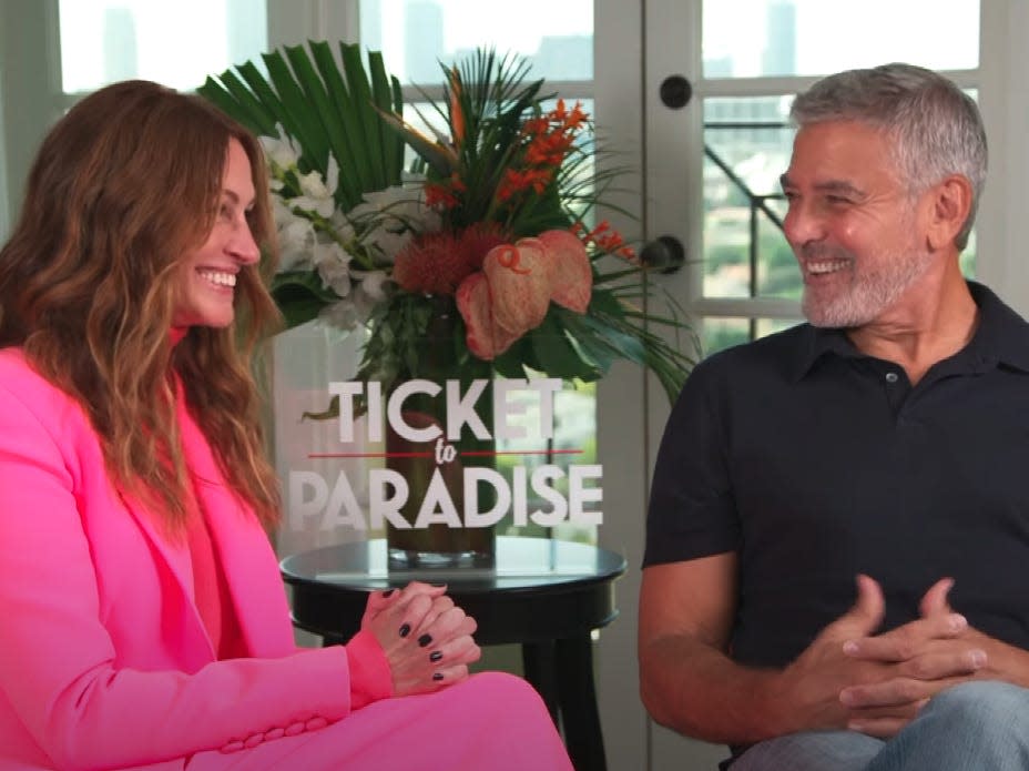 George Clooney reacts to learning how he's saved on his friend Julia Roberts' phone.