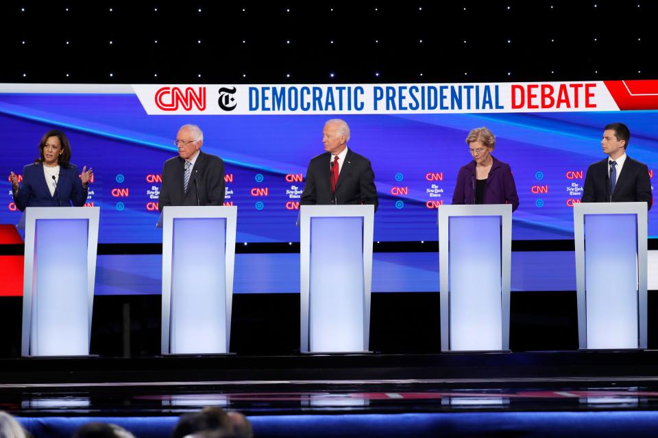 Sen. Kamala Harris, D-Calif., left, speaks as from left, Sen. Bernie Sanders, I-Vt., former Vice President Joe Biden, Sen. Elizabeth Warren, D-Mass., and South Bend Mayor Pete Buttigieg listen during a Democratic presidential primary debate at Otterbein University.