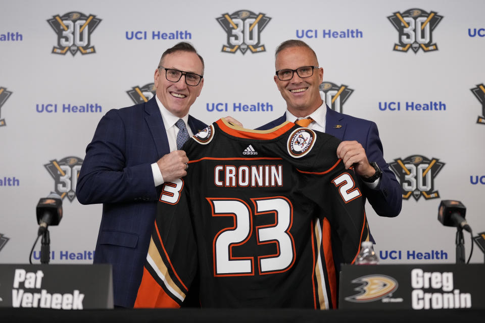 Anaheim Ducks General Manager Pat Verbeek, left, poses with the team's new head coach, Greg Cronin, during a press conference in Anaheim, Calif., Monday, June 5, 2023. (AP Photo/Ashley Landis)