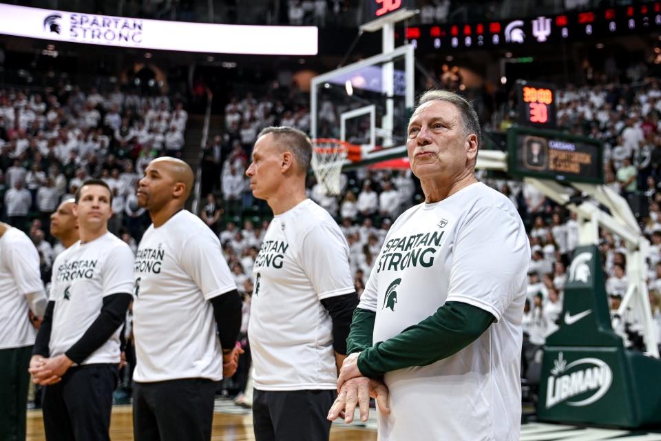 Michigan State's head coach Tom Izzo, right, and the Spartans honor the three killed and five injured in the shooting on campus last week during Michigan State's game against Indiana on Tuesday, Feb. 21, 2023, at the Breslin Center in East Lansing.