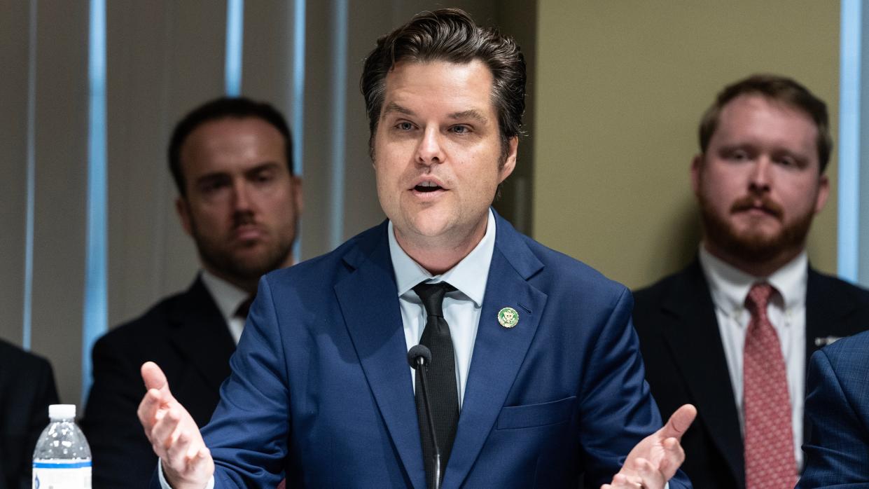 Matt Gaetz in front of a microphone