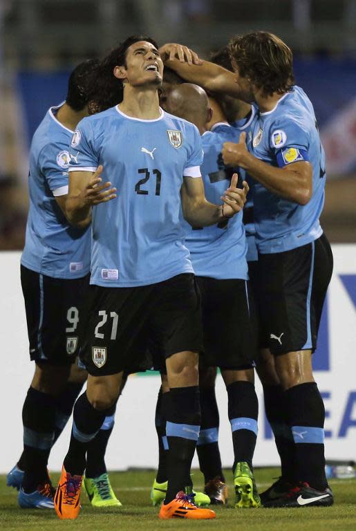 Uruguay's Edison Cavani (C) celebrates scoring a goal during their FIFA 2014 World Cup qualifier match against Jordan, at the International Stadium in Amman, on November 13, 2013