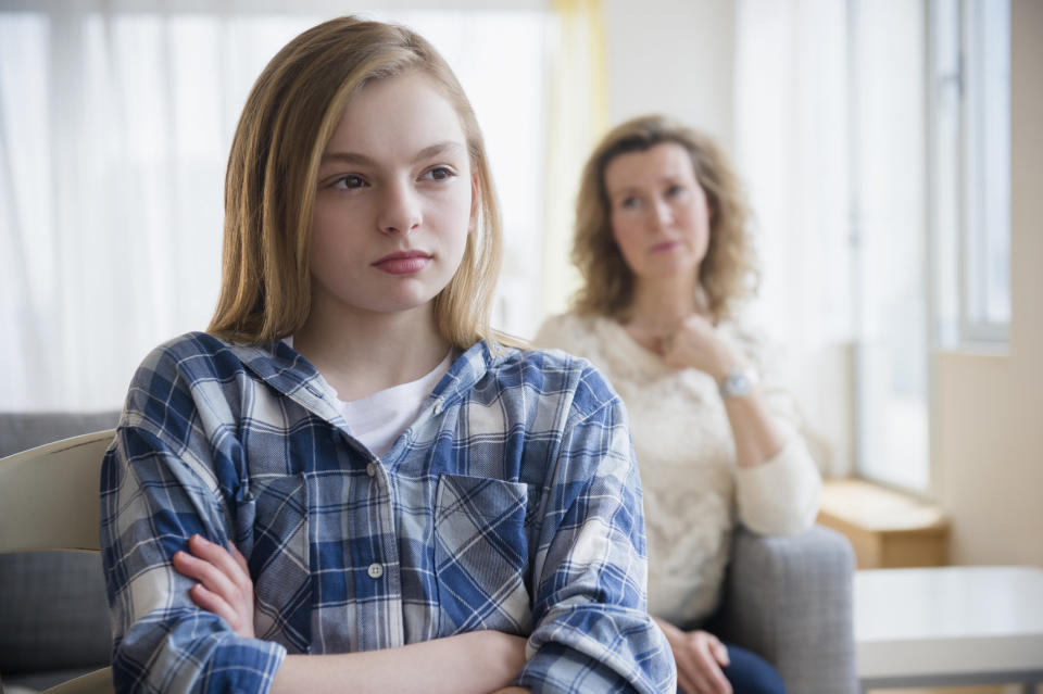 angry daughter with mom in the background