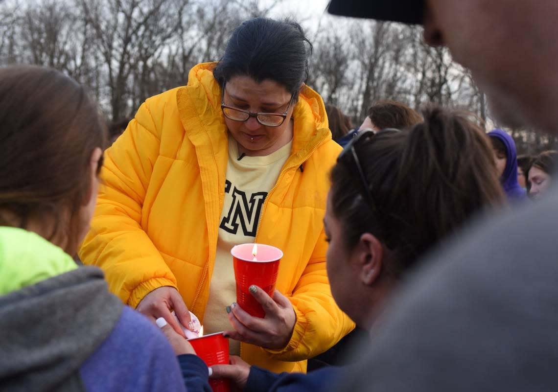 Susan Deedon, whose nephew Jayden Robker was found dead in a Gladstone pond Friday after he had been missing for weeks, lights candles at a vigil Wednesday where roughly 150 people gathered Wednesday evening. Bill Lukitsch