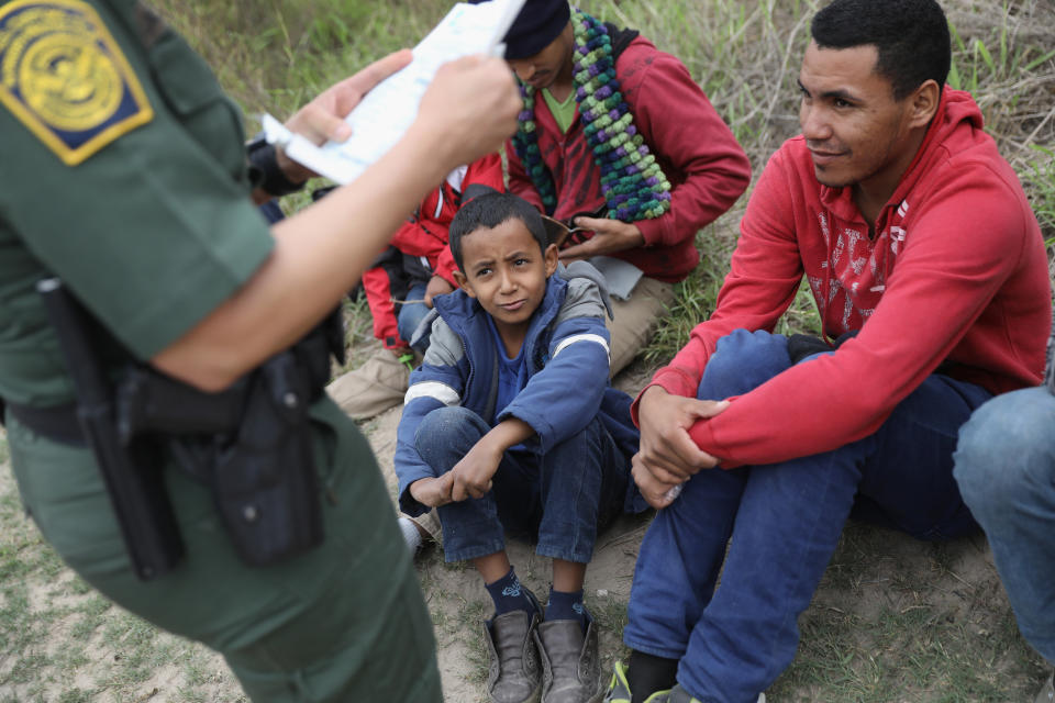 A U.S. Border Patrol agent checks birth certificates while taking Central American immigrants into detention on Jan. 4, 2017, near McAllen, Texas.