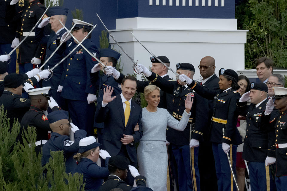 Louisiana Republican Gov.-elect Jeff Landry, center left, arrives with his wife Sharon Landry for his inauguration ceremony at the State Capitol building in Baton Rouge, La., Sunday, Jan. 7, 2024. The inauguration, originally scheduled for Monday, was pushed up a day early due to weather concerns. (AP Photo/Matthew Hinton)