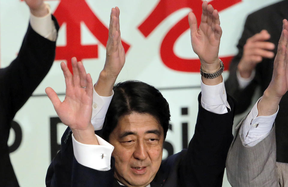 Former Prime Minister Shinzo Abe celebrates after winning his party leader election of Japan's opposition Liberal Democratic Party in Tokyo, Wednesday, Sept. 26, 2012. Abe, known as a hawk and nationalist, won the election Wednesday to become president of the main opposition Liberal Democratic Party. (AP Photo/Itsuo Inouye)