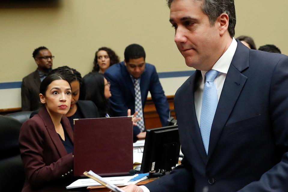 Michael Cohen, right, President Donald Trump's former lawyer, walks past committee member Rep. Alexandria Ocasio-Cortez, D-N.Y., center, during a break in Cohen's testimony before the House Oversight and Reform Committee on Capitol Hill in Washington, Wednesday, Feb. 27, 2019. (AP Photo/Pablo Martinez Monsivais) ORG XMIT: DCPM104