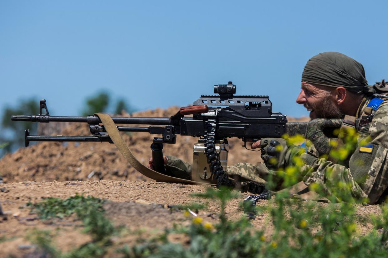 A Ukrainian service member fire a machine gun at a training ground near a frontline in Donetsk (REUTERS)