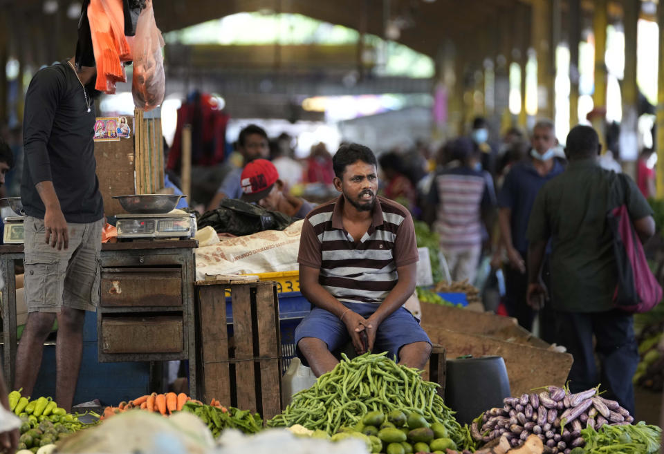 FILE - A vender waits for customers at a vegetable market place in Colombo, Sri Lanka, Friday, June 10, 2022. China’s government on Friday, Feb. 2, 2023, confirmed it is offering Sri Lanka a two-year moratorium on loan repayment as the Indian Ocean island nation struggles to restructure $51 billion in foreign debt that pushed it into a financial crisis. (AP Photo/Eranga Jayawardena)