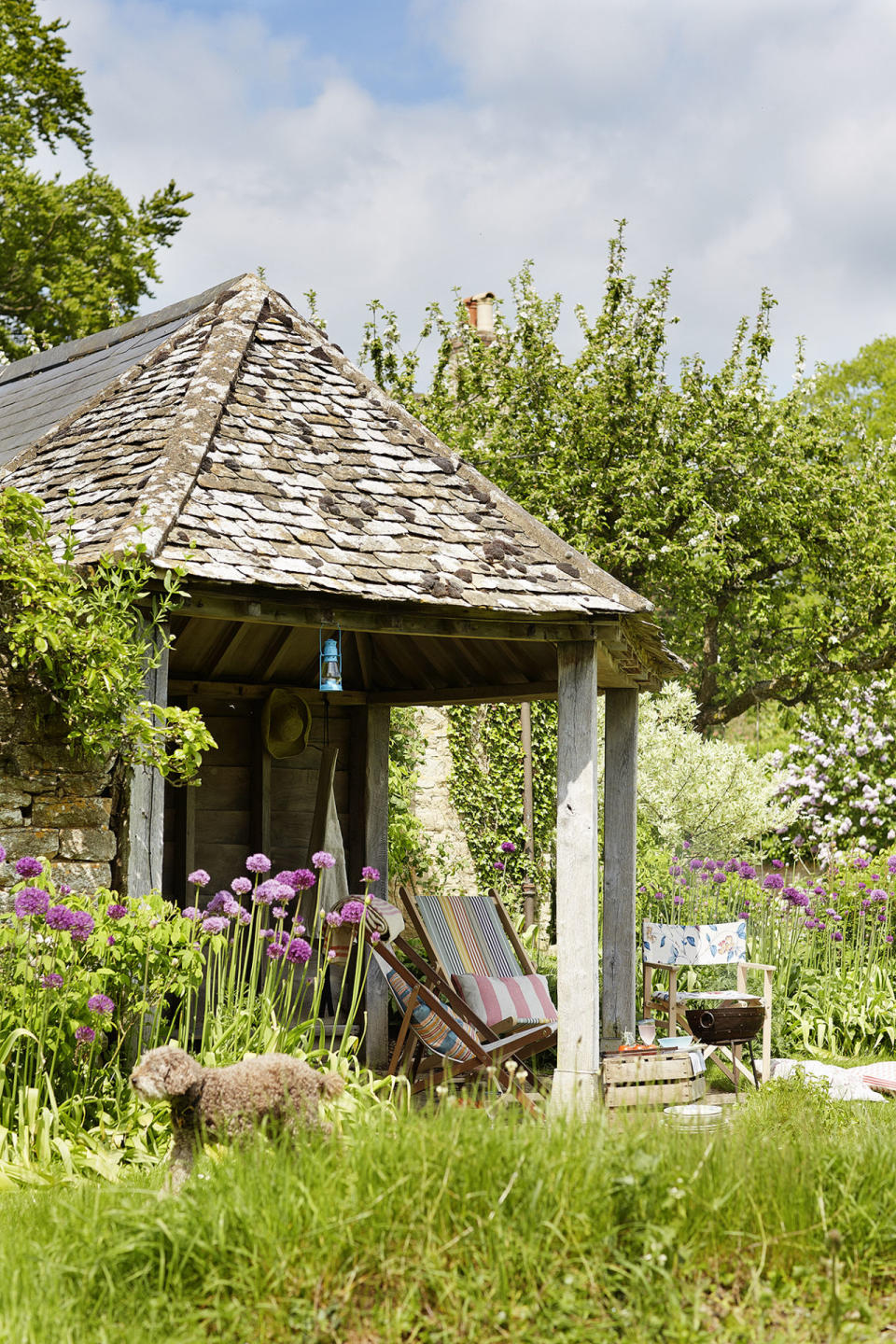 <p>A bespoke open-sided garden building made of green-oak timber and reclaimed limestone provides an ideal place to admire the garden.</p>