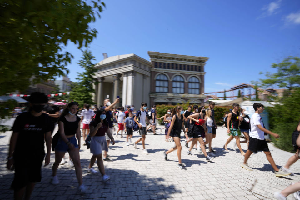 People arrive at Cinecitta World amusement park in the outskirts of Rome in the day of its reopening, Thursday, June 17, 2021. Amusement parks have been closed since Oct. 25 2020, when Italy's second national lockdown started. (AP Photo/Alessandra Tarantino)