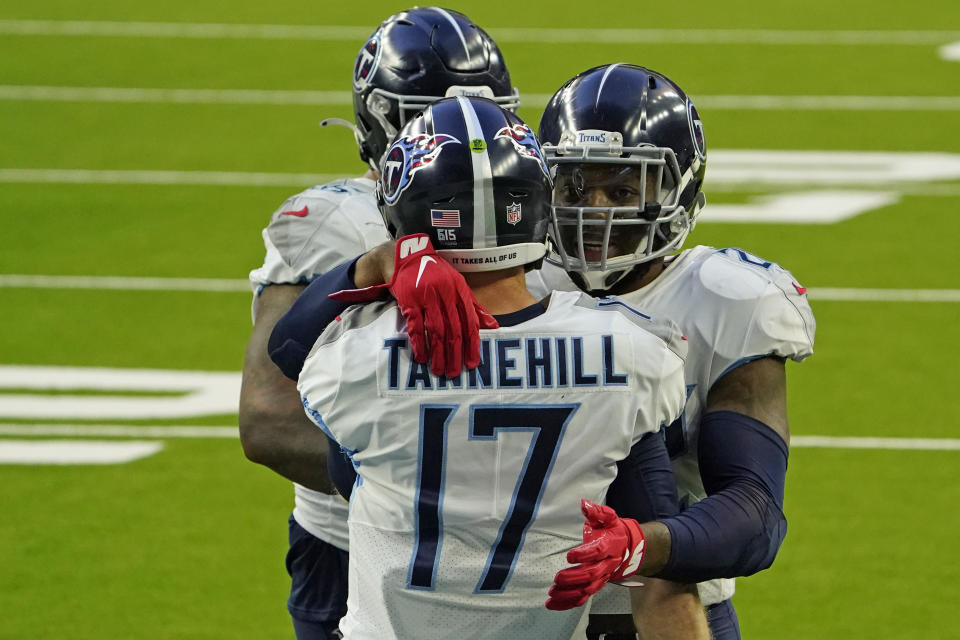 Tennessee Titans running back Derrick Henry, right, celebrates with quarterback Ryan Tannehill (17) after running for a touchdown against the Houston Texans during the second half of an NFL football game Sunday, Jan. 3, 2021, in Houston. (AP Photo/Sam Craft)