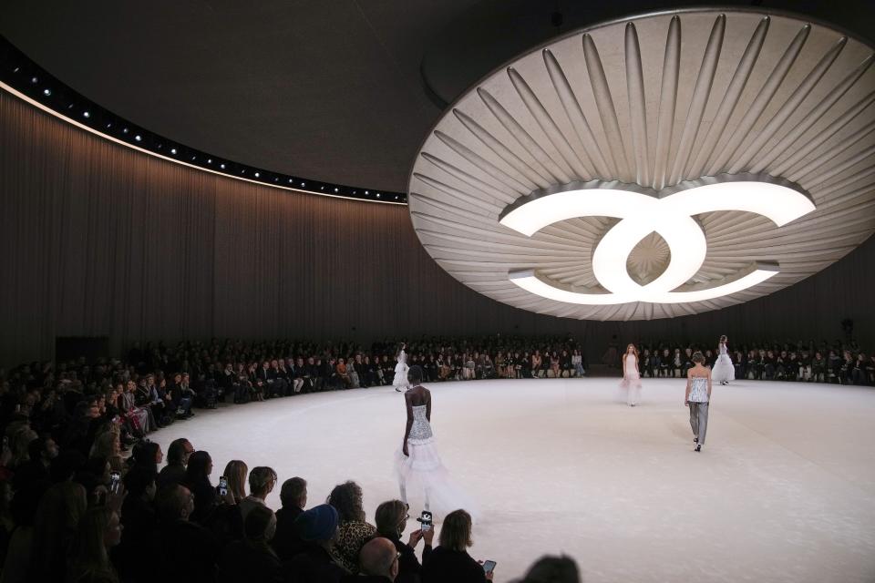 Models wear creations for Chanel as part of the Haute Couture Spring-Summer 2024 collection presented in Paris, Tuesday, Jan. 23, 2024. (AP Photo/Christophe Ena)