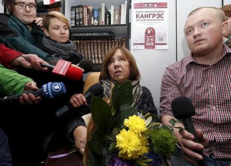 Belarussian author Svetlana Alexievich (C), surrounded by journalists, speaks during a news conference in Minsk, Belarus, October 8, 2015. REUTERS/Vasily Fedosenko