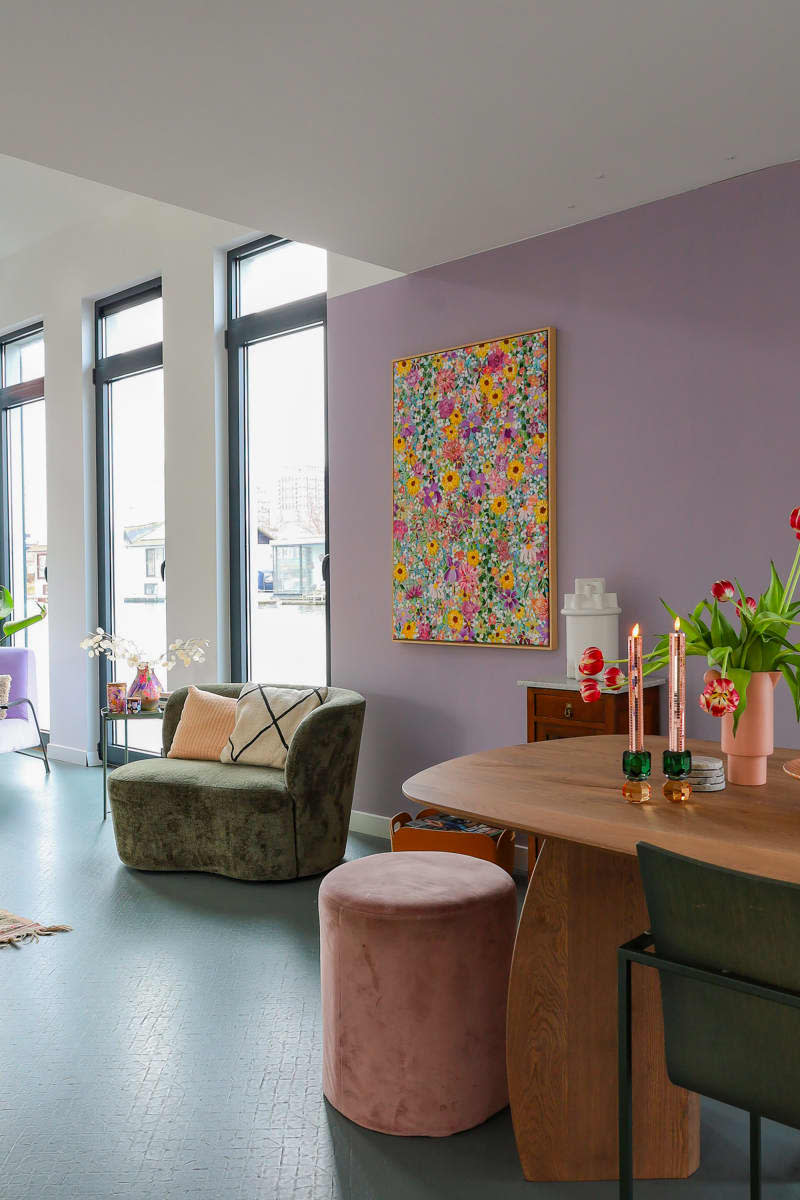 View from dining room with lavender wall and floral art.