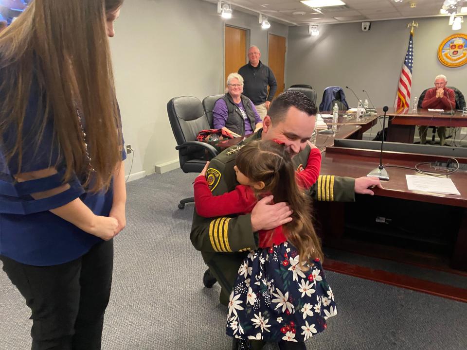 Alex Reno is sworn in as chief of the Hampton Police Department Monday, Dec. 19, 2022, with his wife Kimberley and daughter Arabella.