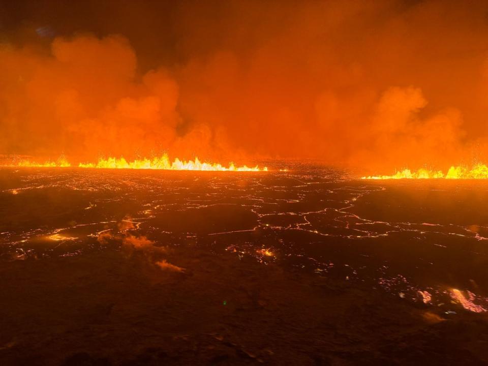 Billowing smoke and flowing lava turning the sky orange. (HANDOUT/AFP via Getty Images)