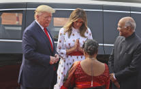 U.S. first lady Melania Trump, center, greets Indian President Ram Nath Kovind's wife wife Savita Kovind, as U.S. President Donald Trump, left, and his Indian counterpart look on during a ceremonial welcome for Trump at the Indian Presidential Palace in New Delhi, India, Tuesday, Feb. 25, 2020. (AP Photo/Manish Swarup)