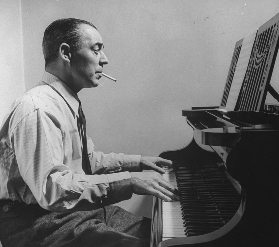EGOT winner composer Richard Rodgers smoking a cigarette while playing the piano<p>George Karger/Getty Images</p>