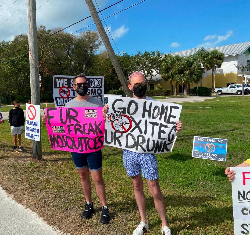 Jessie Moreno and Robert Cartwright hold signs during a protest outside the Murray Nelson Government and Cultural Arts Center in Key Largo Sunday, Feb. 21, 2021. The protest was over a plan by a British biotech company to release millions of genetically modified mosquitoes within the Florida Keys in an effort to combat the invasive Aedes aegypti species.