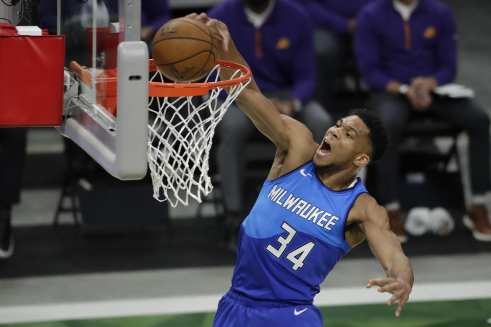 Milwaukee Bucks' Giannis Antetokounmpo dunks during the first half of an NBA basketball game against the Phoenix Suns Monday, April 19, 2021, in Milwaukee. (AP Photo/Aaron Gash)