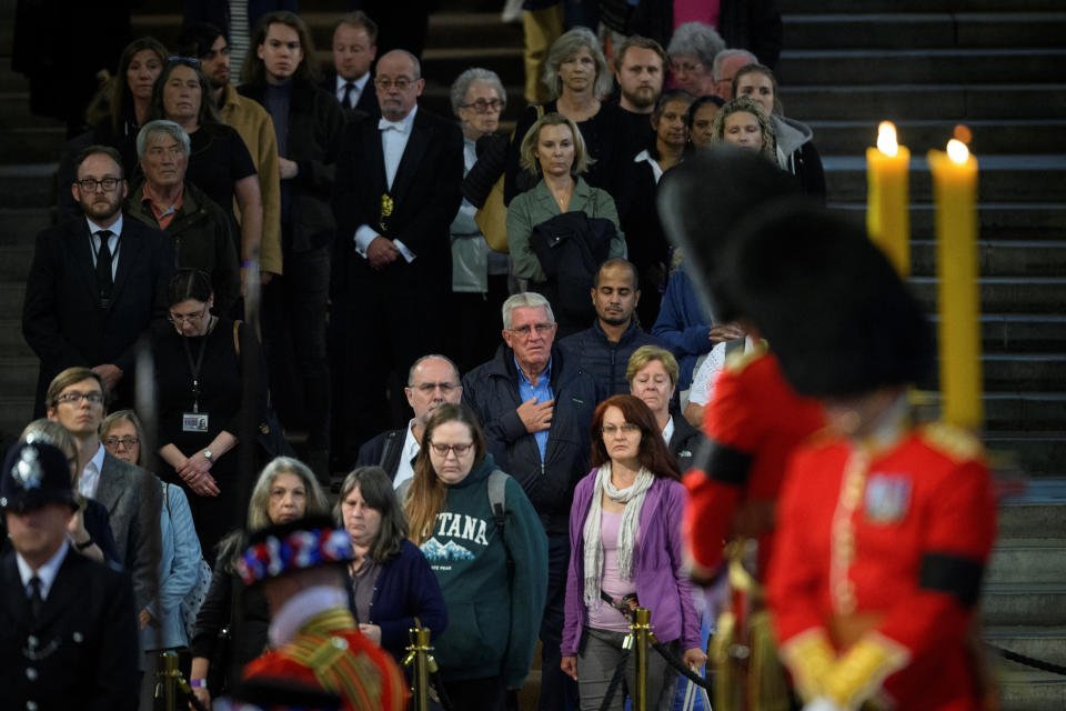 LONDON, ENGLAND - SEPTEMBER 15: Members of the public react as they see the coffin after waiting to pay their respects to Queen Elizabeth II at Westminster Hall on September 15, 2022 in London, England. Leon Neal/Pool via REUTERS