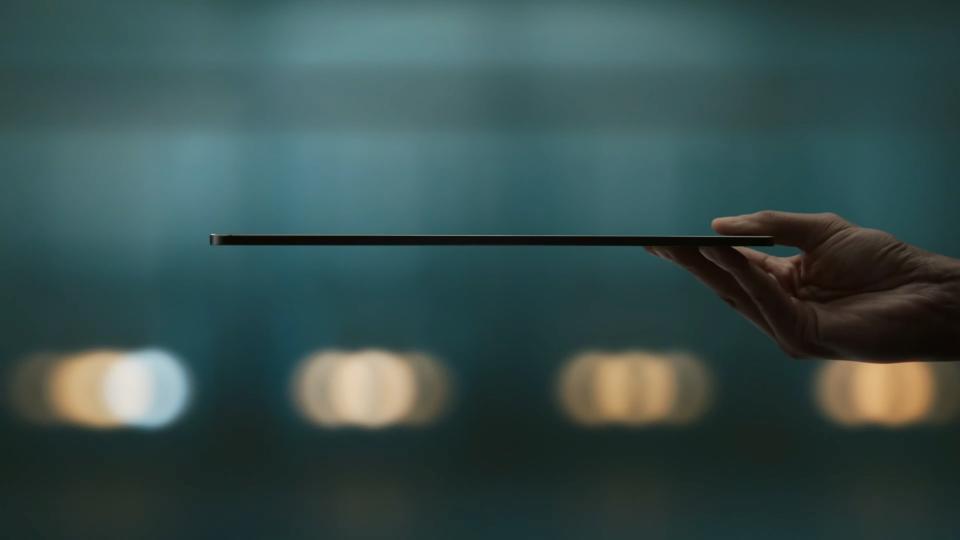 An Apple iPad Pro OLED held flat to show how slim it is