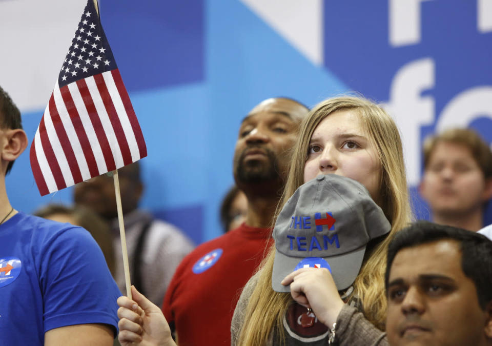 Supporters look on