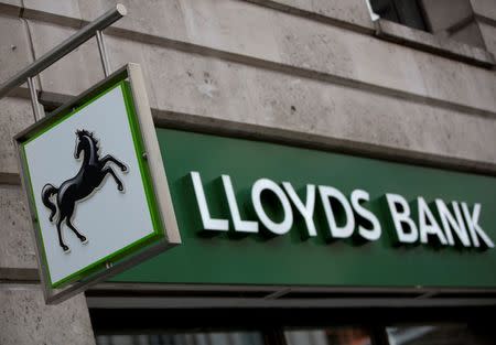 A sign is seen outside a branch of Lloyds Bank in the City London February 3, 2014. Lloyds Banking Group dashed investors' hopes of receiving a dividend for 2013 after it took a further 1.8 billion pound ($3 billion) mis-selling charge that will blunt its ability to make shareholder payouts until next year. REUTERS/Neil Hall (BRITAIN - Tags: BUSINESS) - RTX186B4