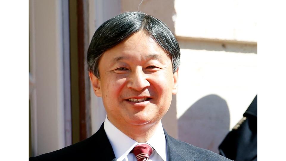 Emperor Naruhito smiling in a suit and tie