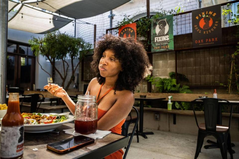 Chynna Morgan of Vallejo has lunch at Fixins, former Sacramento mayor Kevin Johnson’s soul food spot in Oak Park, in July. The East Bay is potential site for expansion.