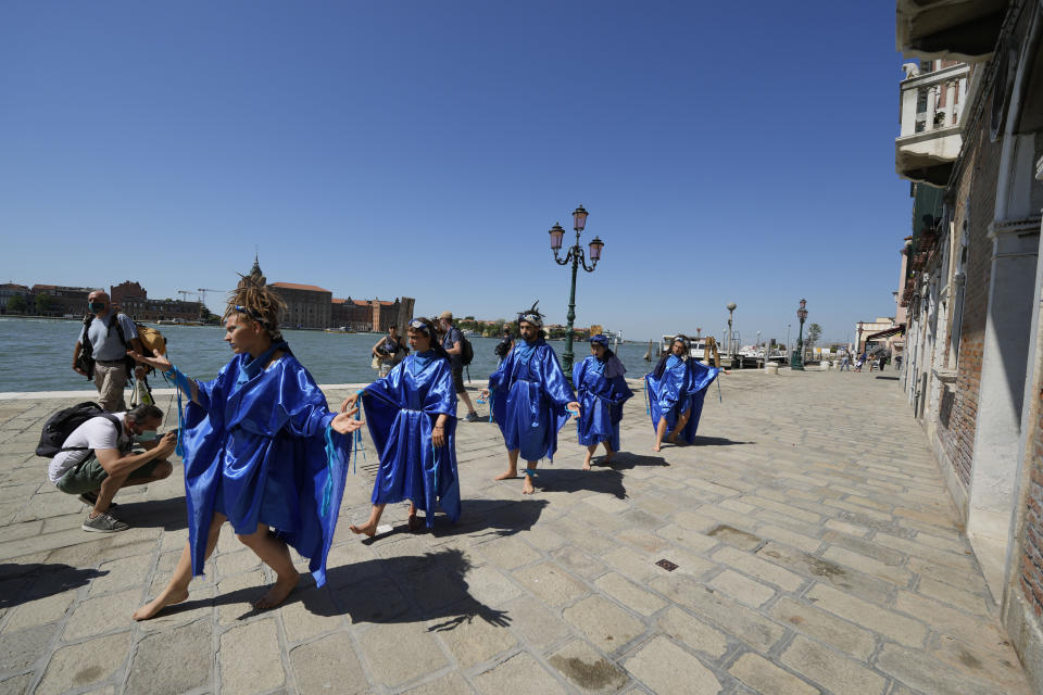 Participants in fish costumes perform on a protest event of the environmental protection movement Animal Rebellion during the G20 Economy and Finance ministers and Central bank governors' meeting in Venice, Italy, Saturday, July 10, 2021. (AP Photo/Luca Bruno)