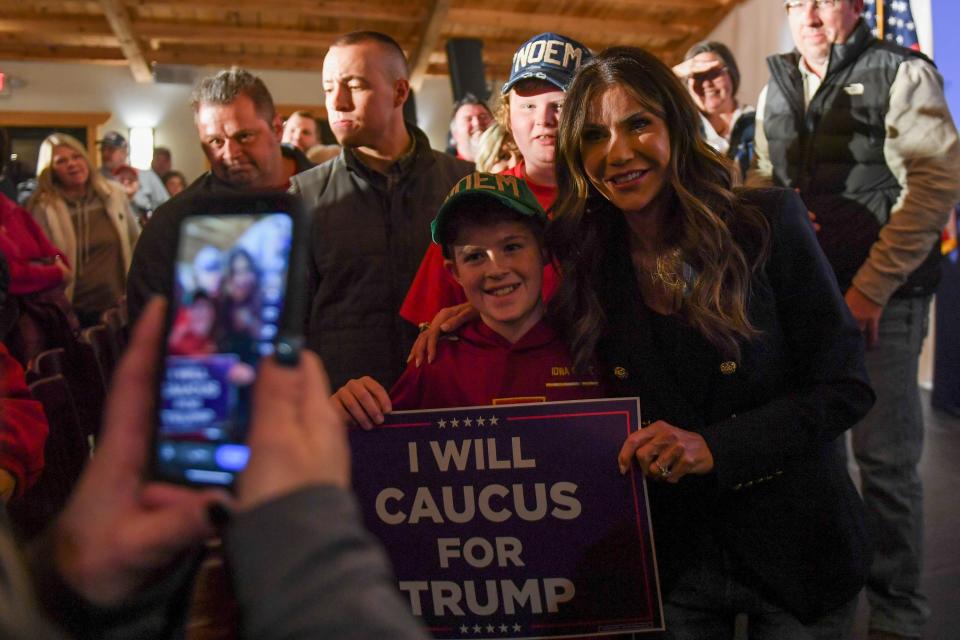 Gov. Kristi Noem takes pictures with attendees during a caucus event in support of Donald Trump on Wednesday, Jan. 3, 2024 at County Celebrations Center in Sioux City, Iowa.