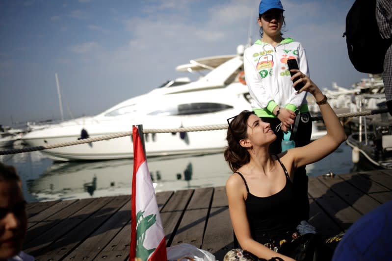 People take part in the ongoing anti-government protests in Beirut