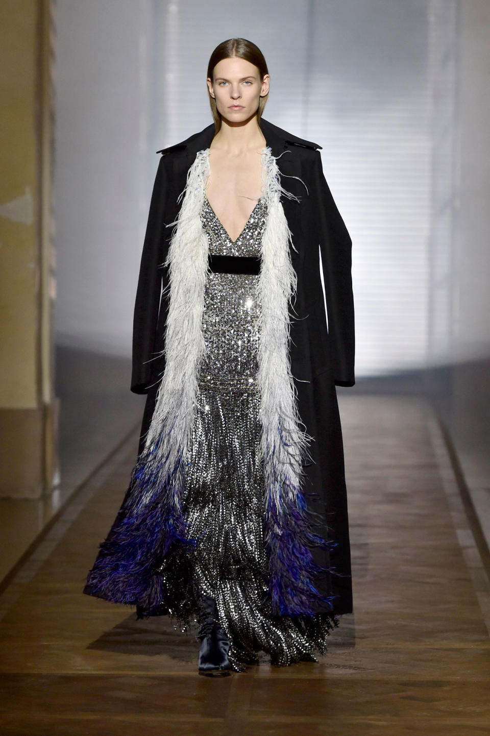 <p>Model wears a silver sequined and beaded fringe gown under a black feather-trimmed coat from the Givenchy SS18 Haute Couture show. (Photo: Getty Images) </p>