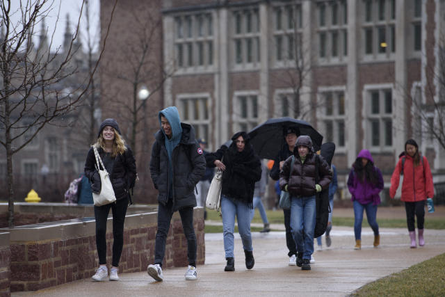Students walk through campus at Washington University in St. Louis.
