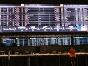 In this June 27, 2019 photo, a gambler places a bet at the new sportsbook at Bally's casino in Atlantic City, N.J. New Jersey surpassed Nevada in terms of sports betting volume in May, taking the national lead for the first time. (AP Photo/Wayne Parry)