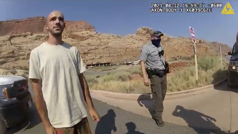 In this image taken from police body camera video provided by the Moab Police Department, Brian Laundrie talks to a police officer after police pulled over the van he was traveling in with his girlfriend, Gabrielle “Gabby” Petito, near the entrance to Arches National Park in Utah on Aug. 12, 2021.